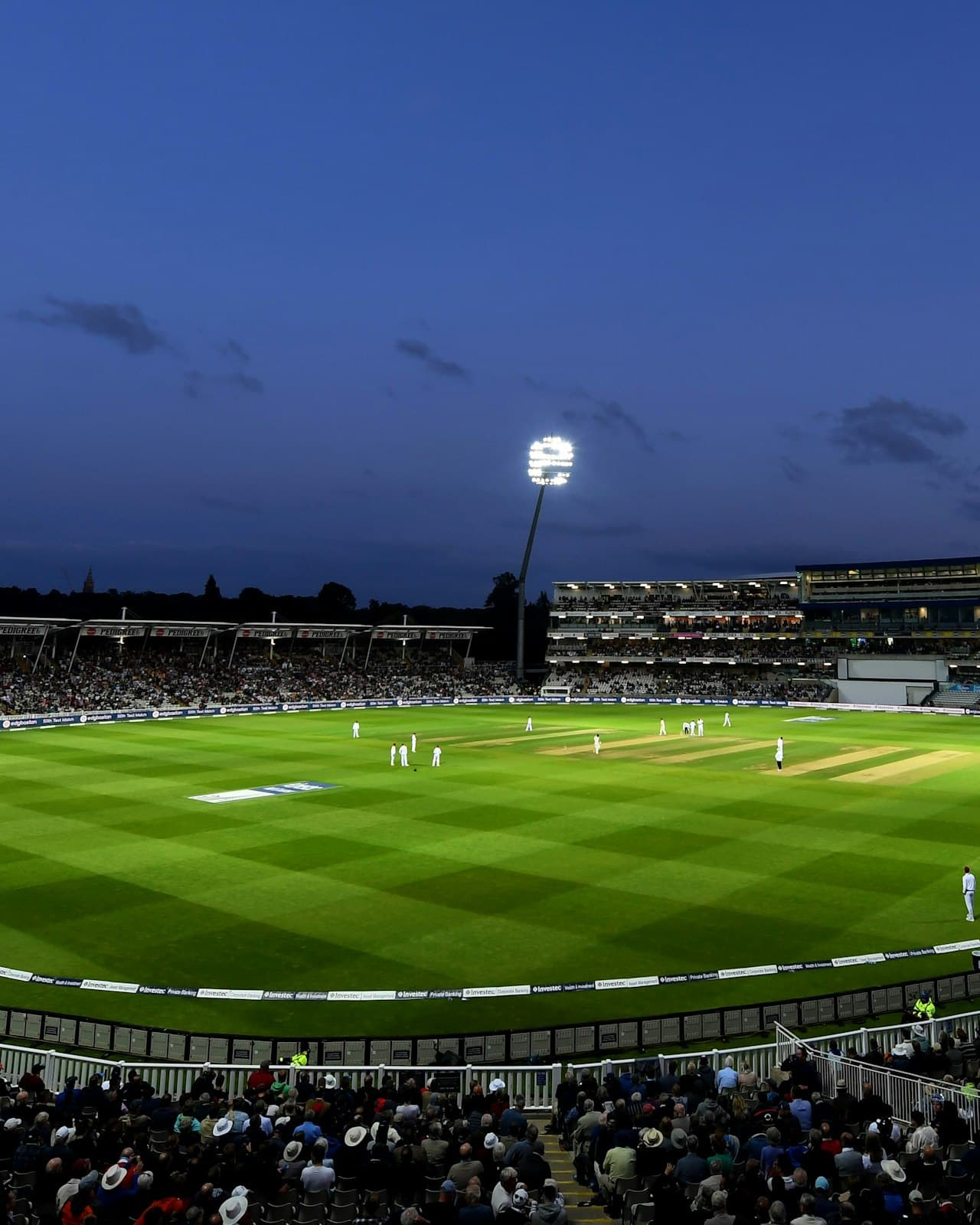 Floodlit stadium under a night sky